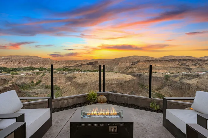 Expansive outdoor patio with stamped concrete surface and a gas fire pit