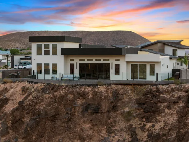 Modern architectural residence featuring a white stucco exterior with dark trim accents