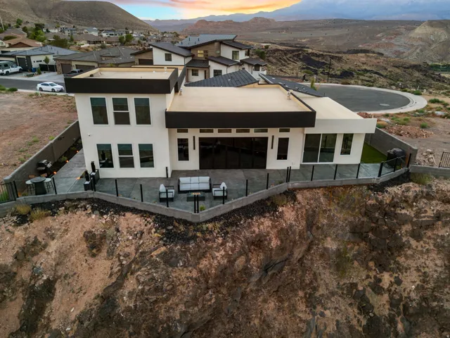 Contemporary residence featuring a flat roofline and extensive rear patio