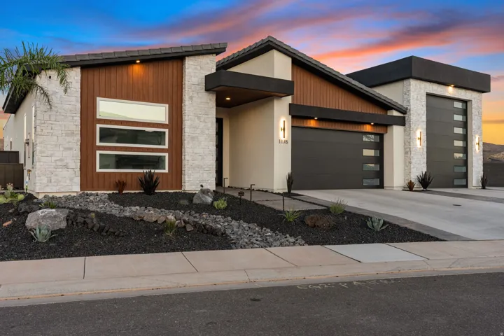 Contemporary exterior featuring stacked stone, wood-finish siding, and stucco accents