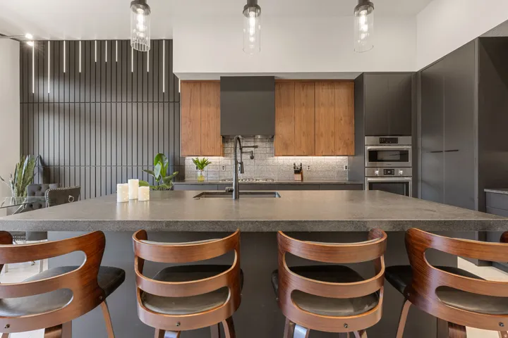 Spacious kitchen island featuring a dark countertop and integrated sink