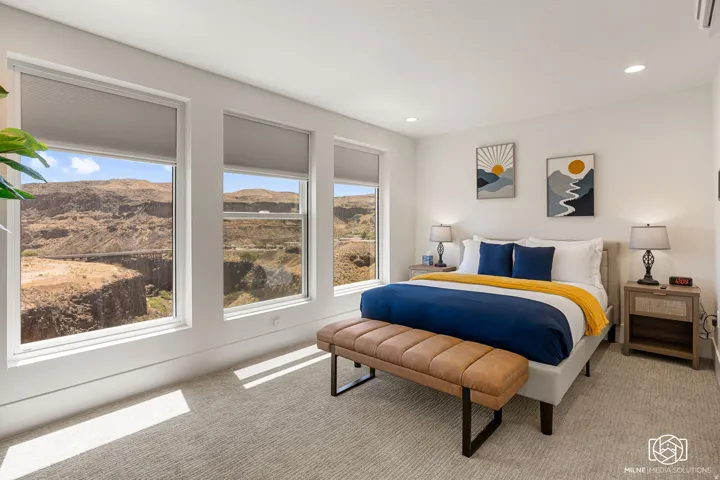 ADU bedroom featuring three large windows with roller shades, recessed lighting, and wall-to-wall carpeting