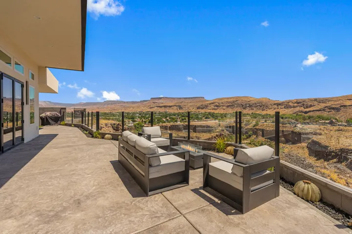Expansive outdoor patio with stamped concrete flooring and a glass panel railing system