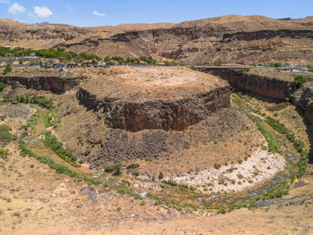 Natural rock formation with a river winding through a canyon landscape