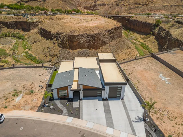 Contemporary residence featuring a multi-tone exterior, an attached multi-car garage, and a patterned concrete driveway