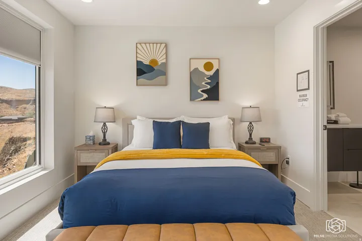 ADU bedroom featuring a large window, recessed lighting, and a neutral color palette
