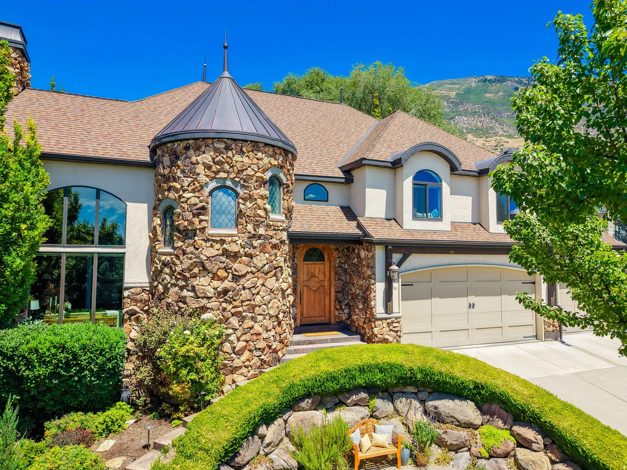 Stone-clad turret entry with a conical metal roof