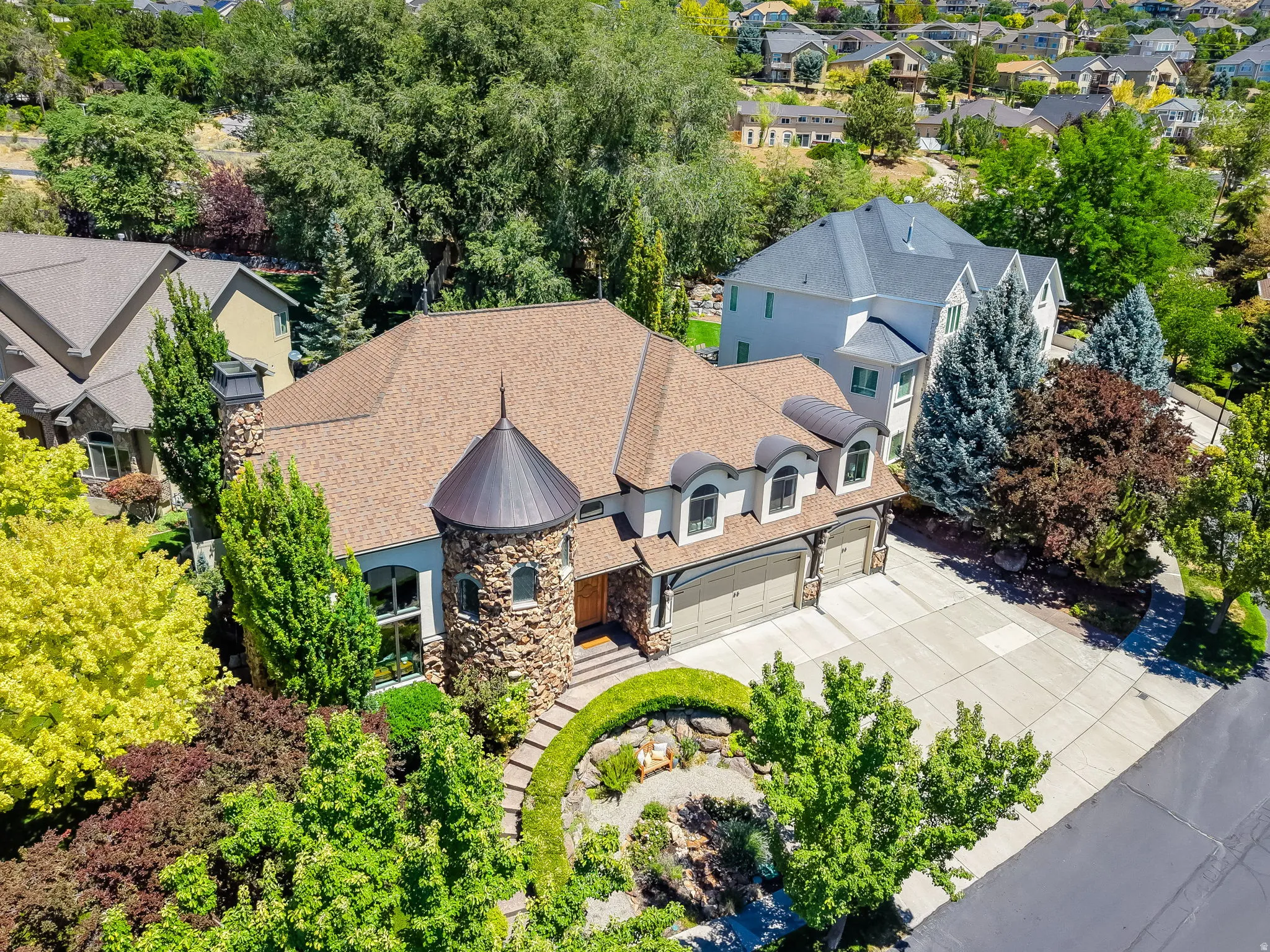 Stone and stucco exterior featuring a prominent turret with a conical roof