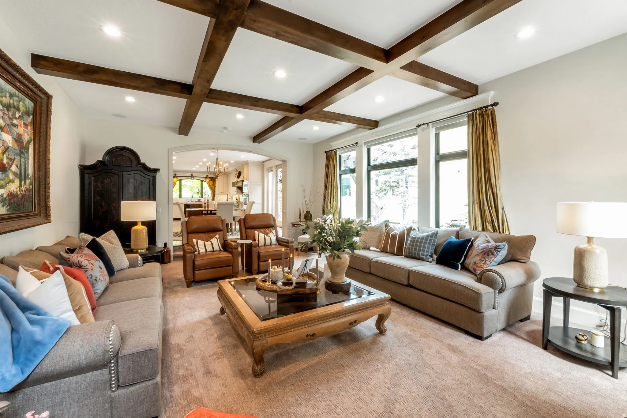 Living area featuring a coffered ceiling with wood-finish beams and recessed lighting