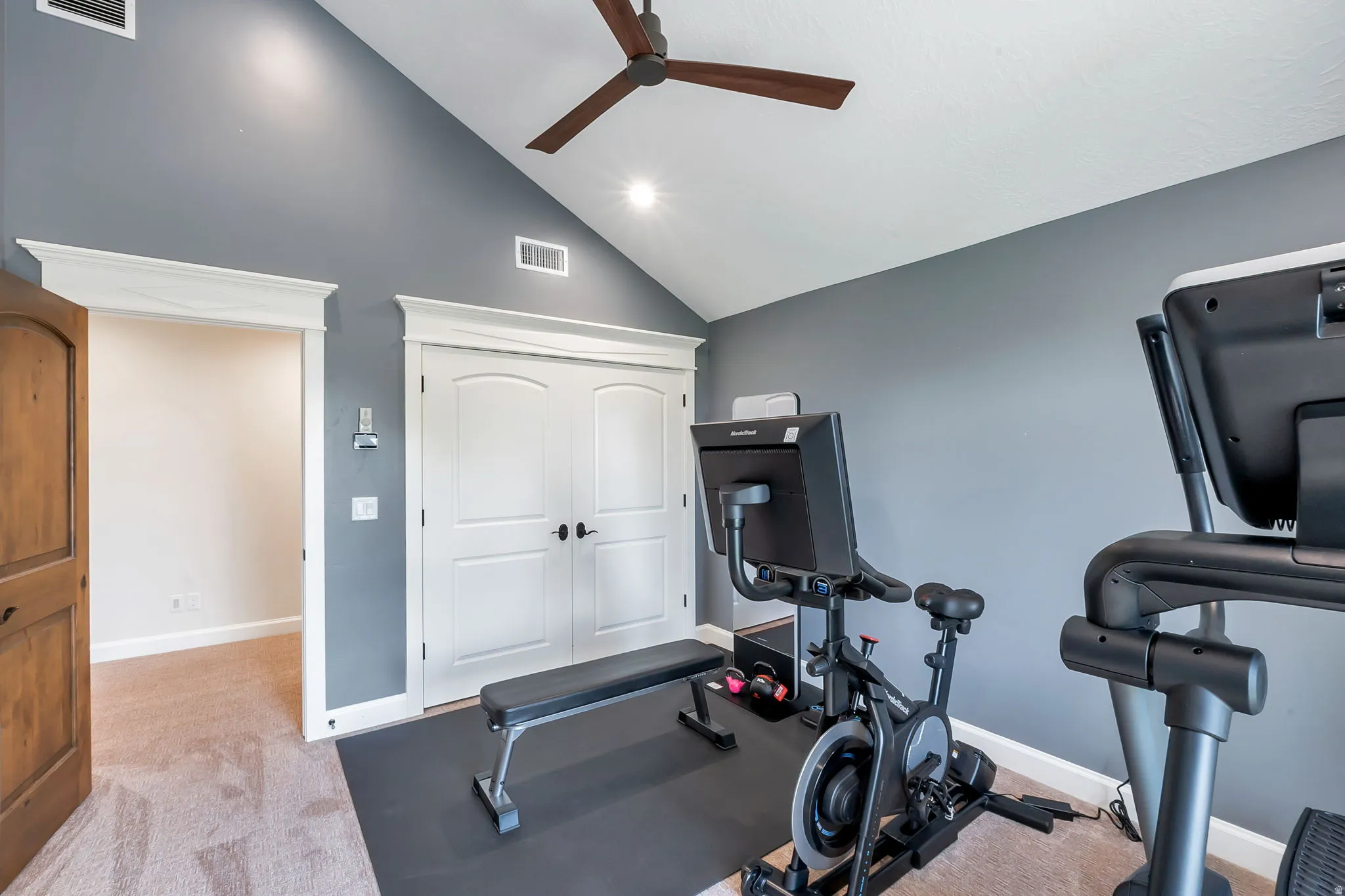 Room featuring a vaulted ceiling with a ceiling fan, recessed lighting, and a neutral carpeted floor