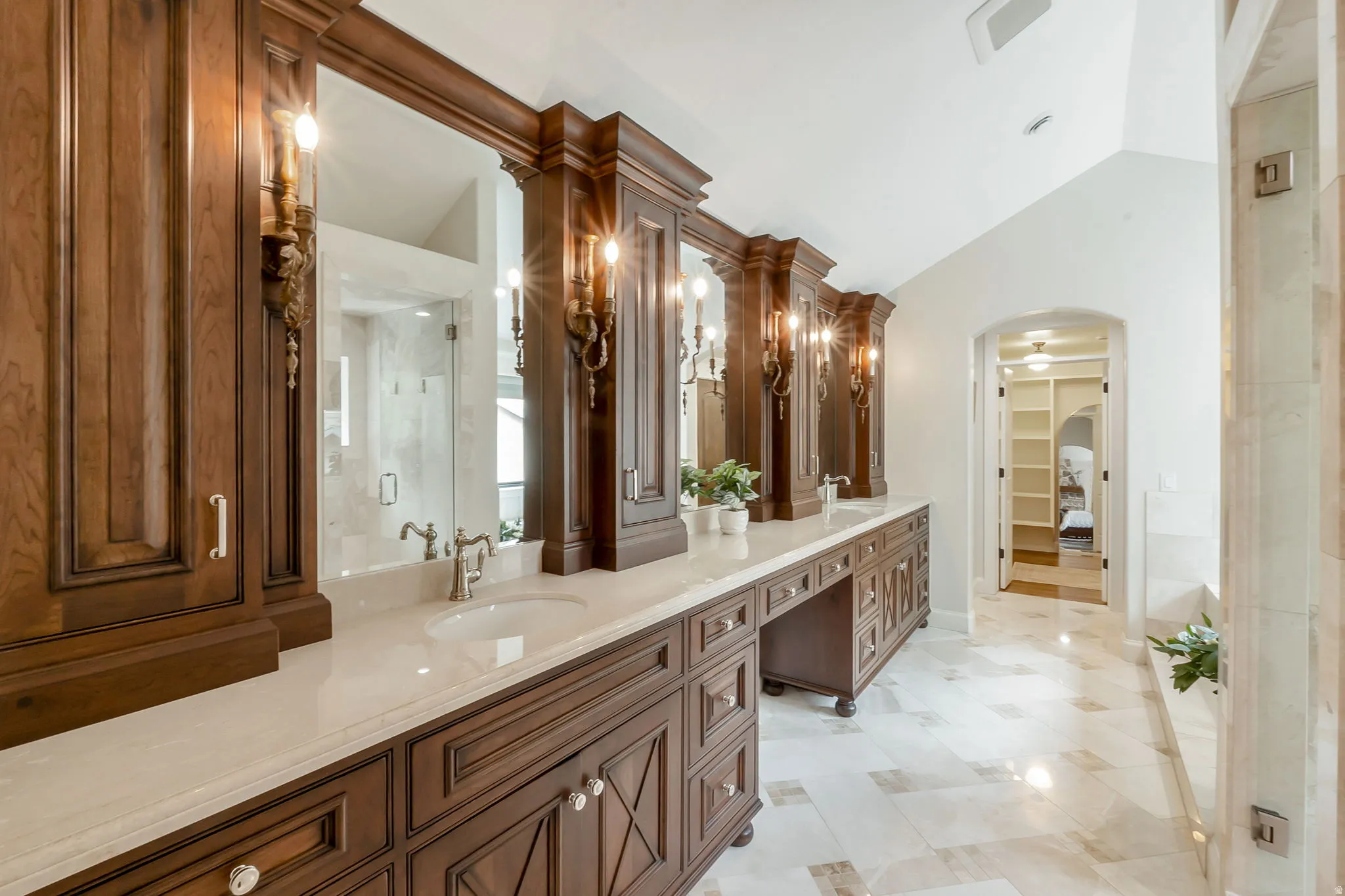Double vanity with wood-finish cabinetry and light-toned countertops