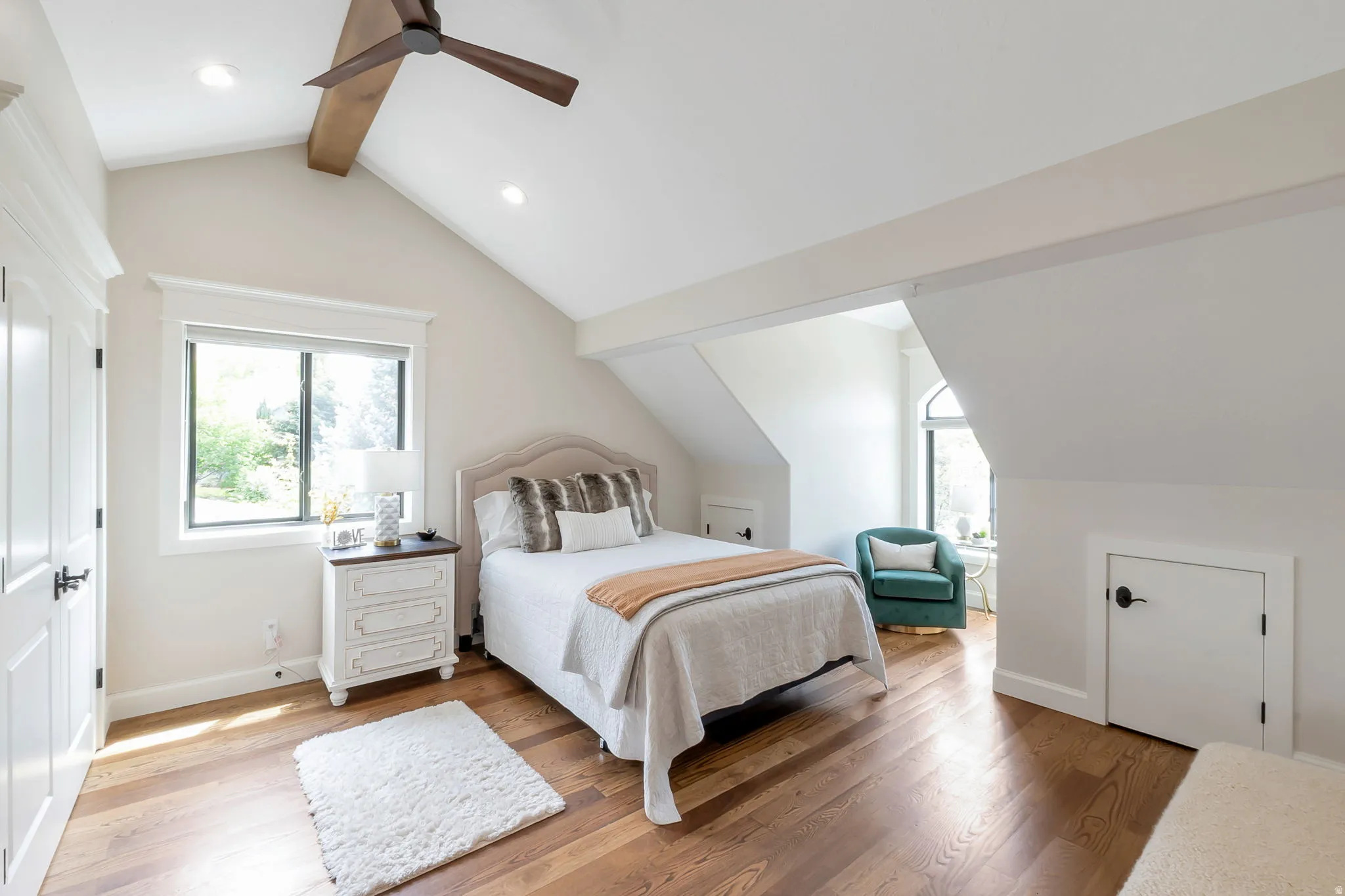 Vaulted ceiling bedroom featuring wood-finish flooring and recessed lighting