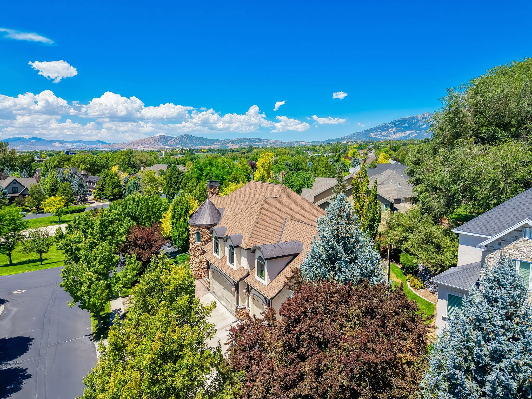 Grand residence with a prominent turret feature and stone accents