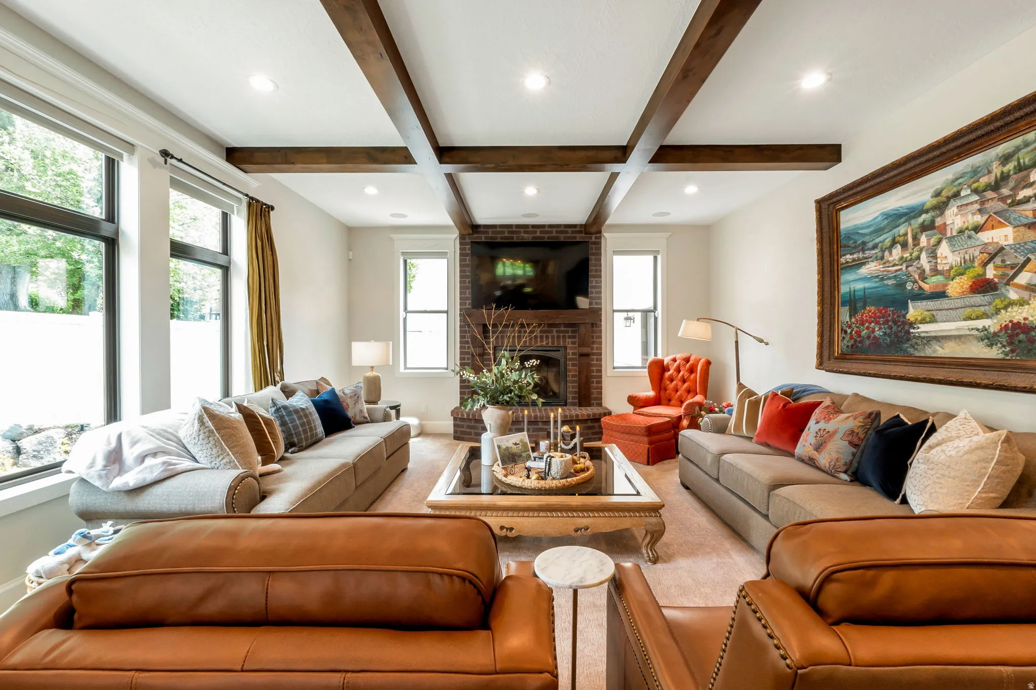 Living area featuring wood-beam ceiling details and recessed lighting