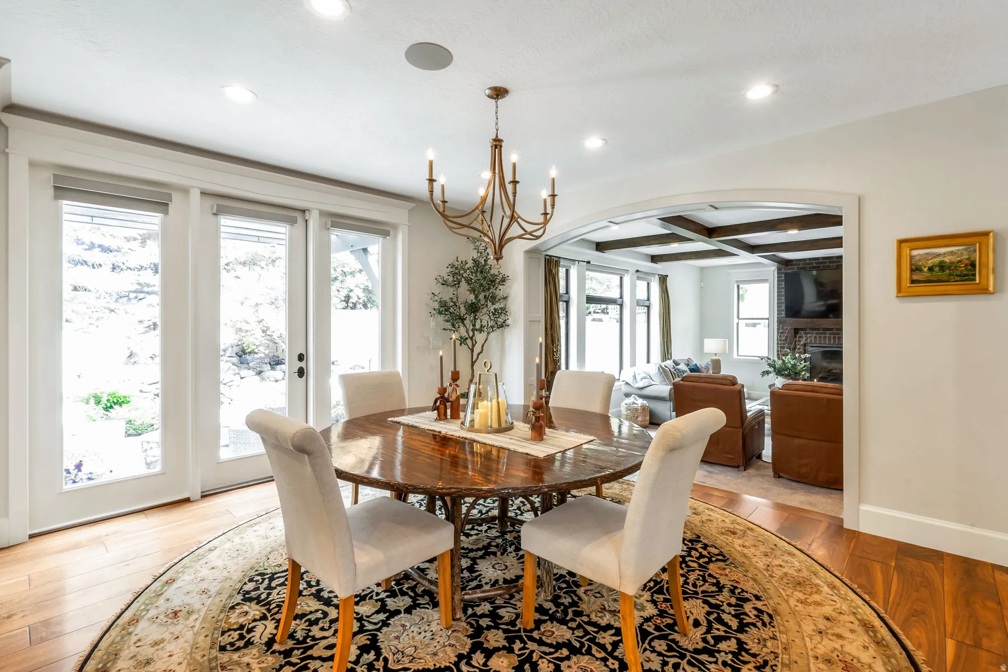 Dining area with wood-finish flooring, a brass chandelier, and recessed lighting