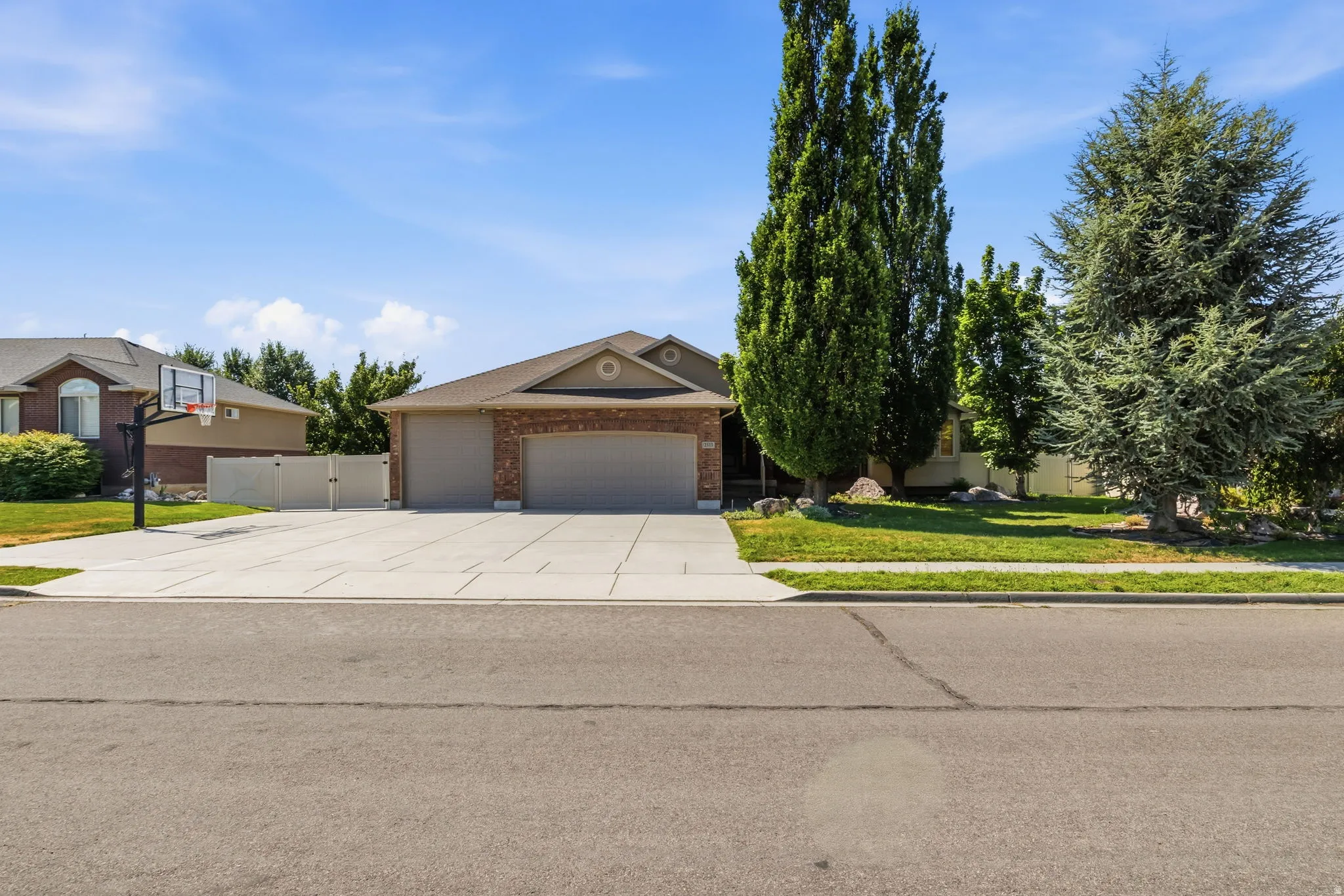Brick and siding exterior featuring a two-car garage with a concrete driveway