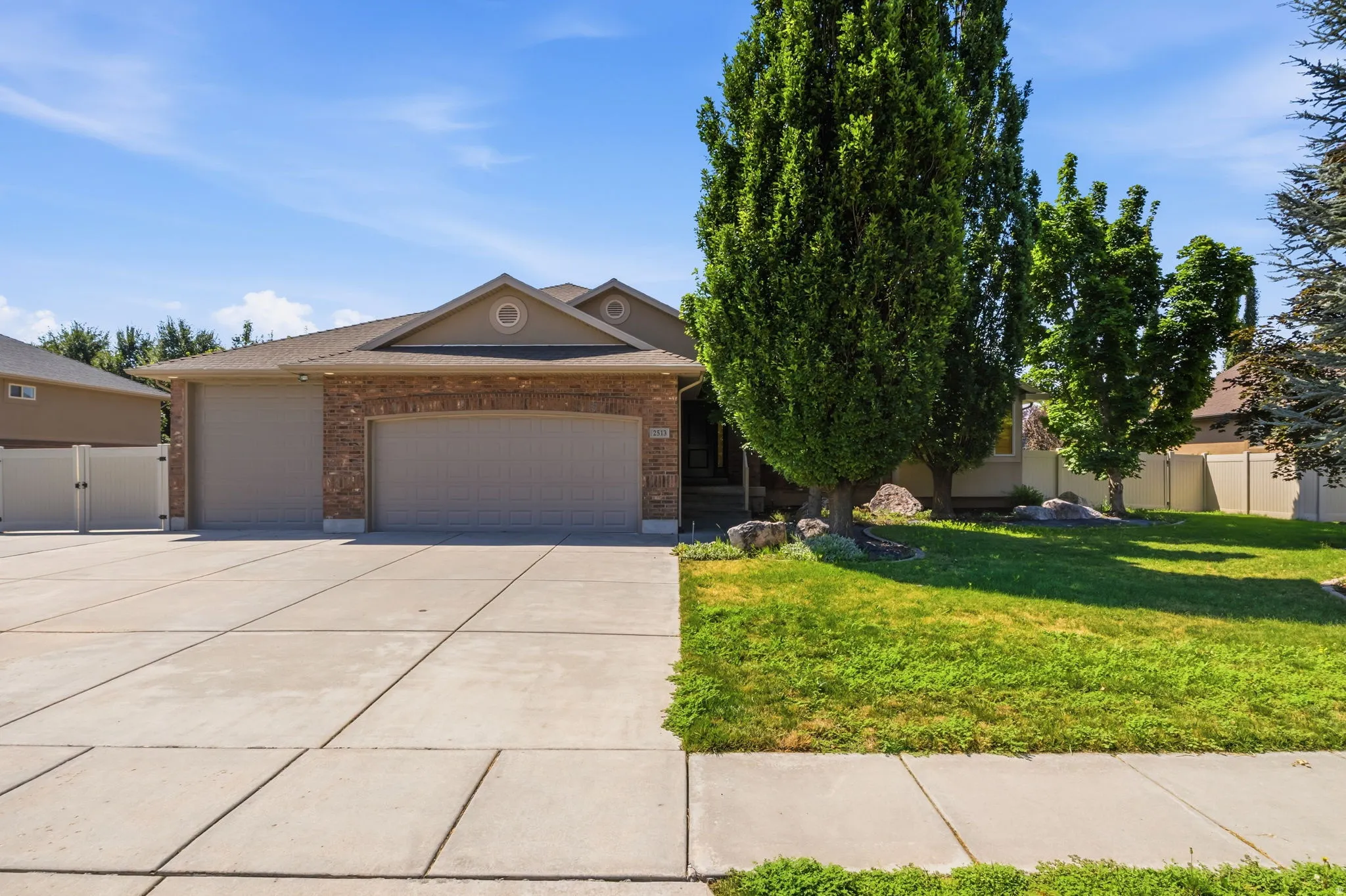 Brick and stucco exterior with a prominent two-car garage