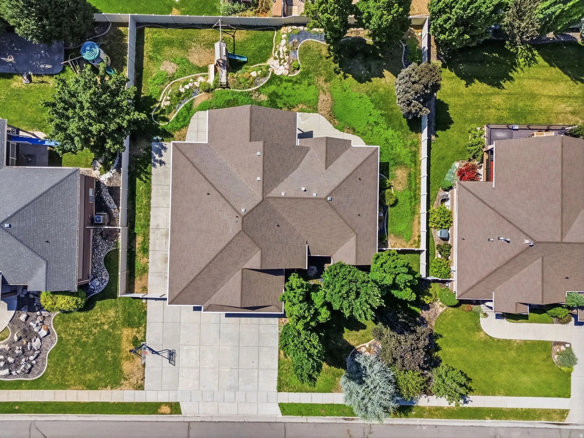 Aerial perspective showcasing a property with a brown shingle roof