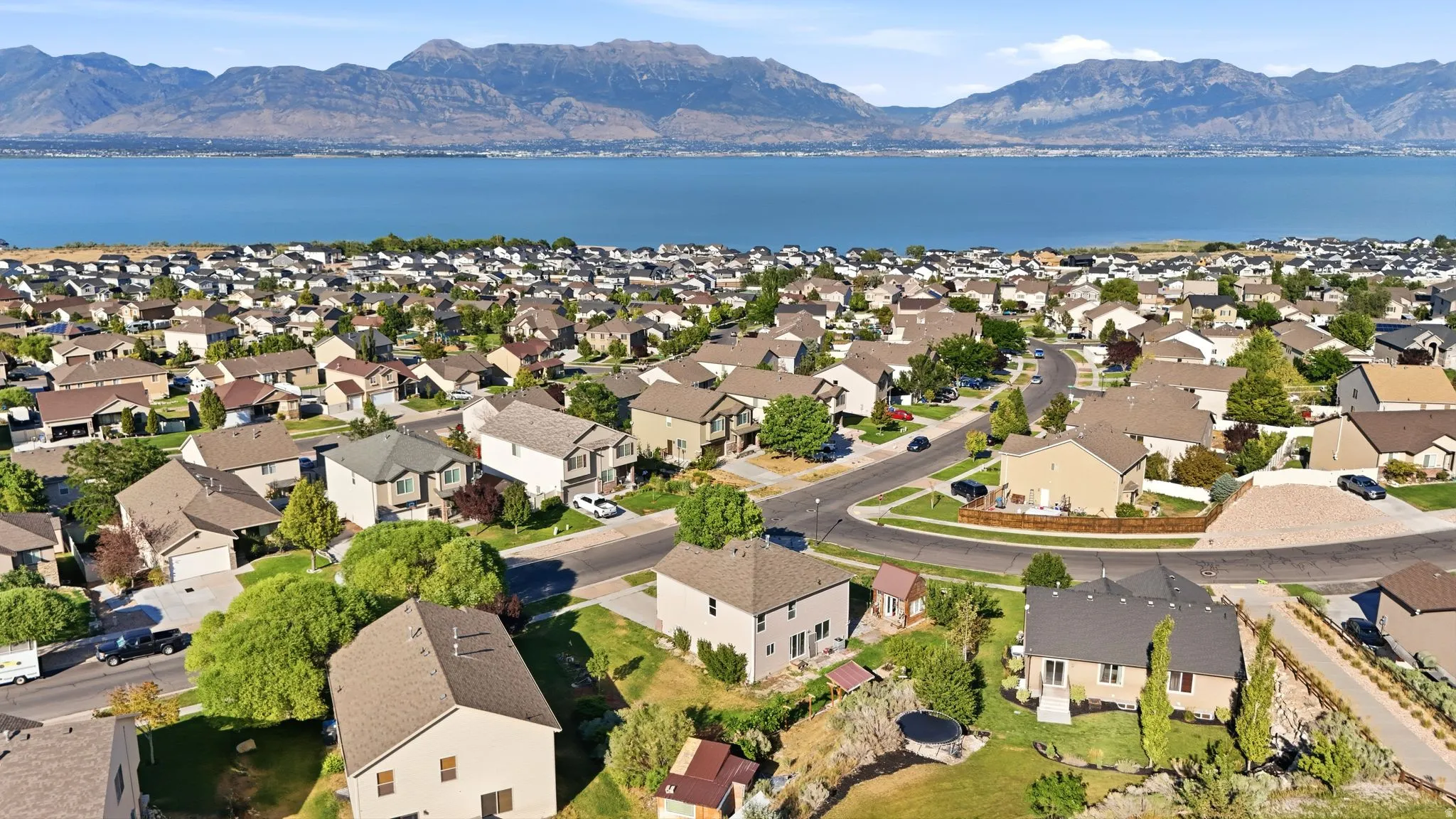 Residential neighborhood featuring a lake and mountain backdrop