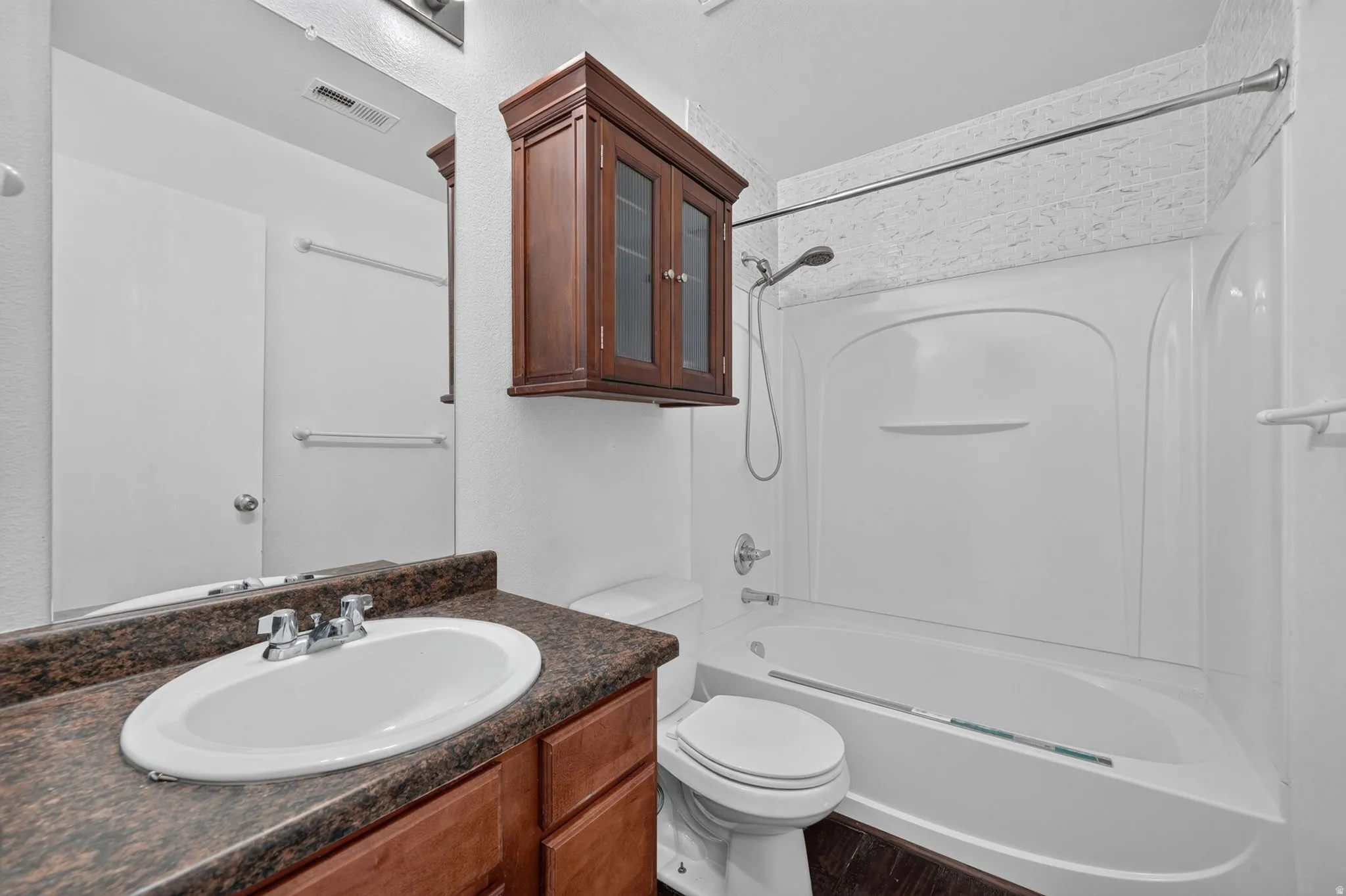 Bathroom featuring a white bathtub and shower combination with a curved shower curtain rod