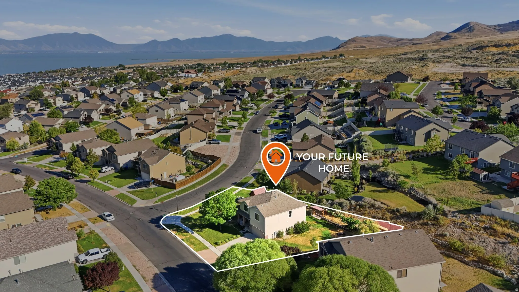 Aerial perspective of a suburban neighborhood featuring a single-family residence with a light-colored exterior and a prominent front yard