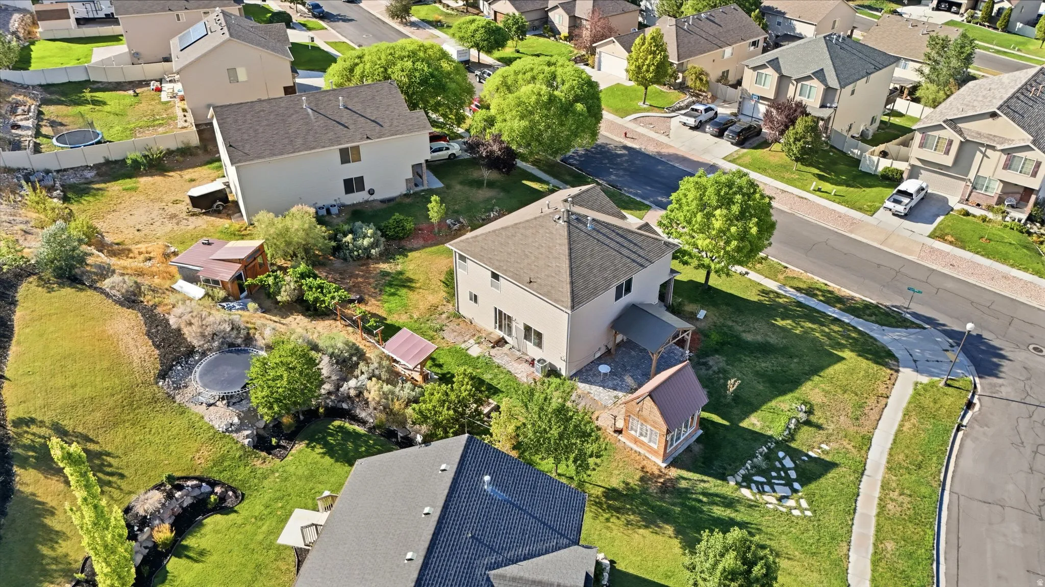 Aerial perspective showcasing a residential property with a multi-level backyard