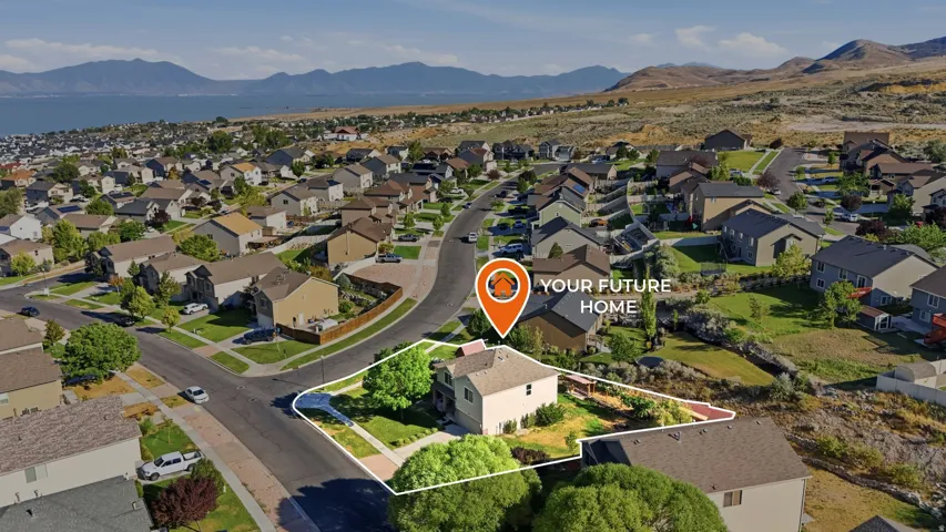 Aerial perspective of a suburban neighborhood featuring a single-family residence with a light-colored exterior and a prominent front yard