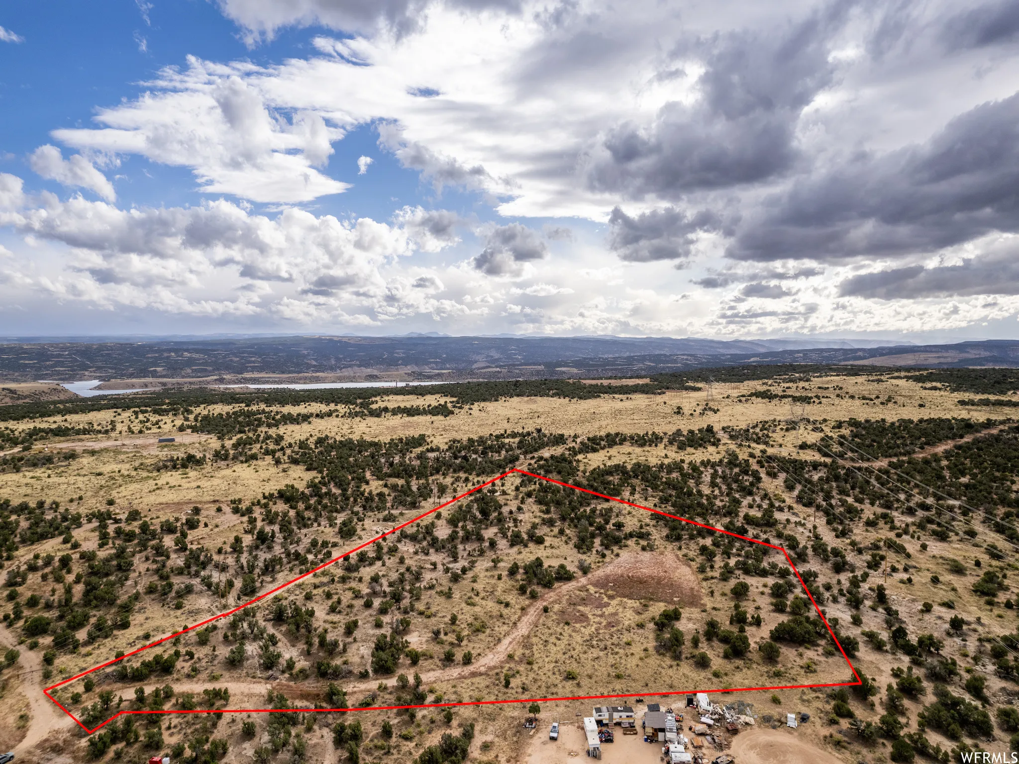 Expansive undeveloped land featuring natural terrain and distant water