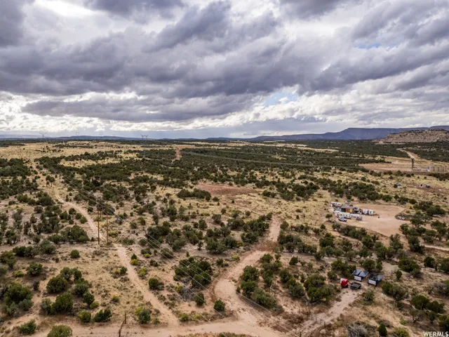 Expansive desert landscape featuring scattered green vegetation and rolling terrain