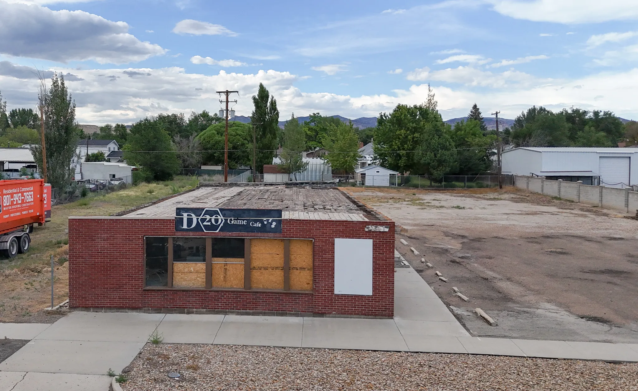 Brick commercial building featuring a flat roof and multiple window openings