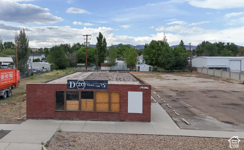 Brick commercial building featuring a flat roof and multiple window openings