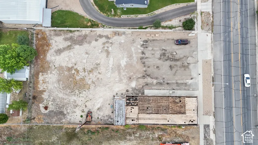 Large lot featuring an existing structure, undeveloped land, and paved road access