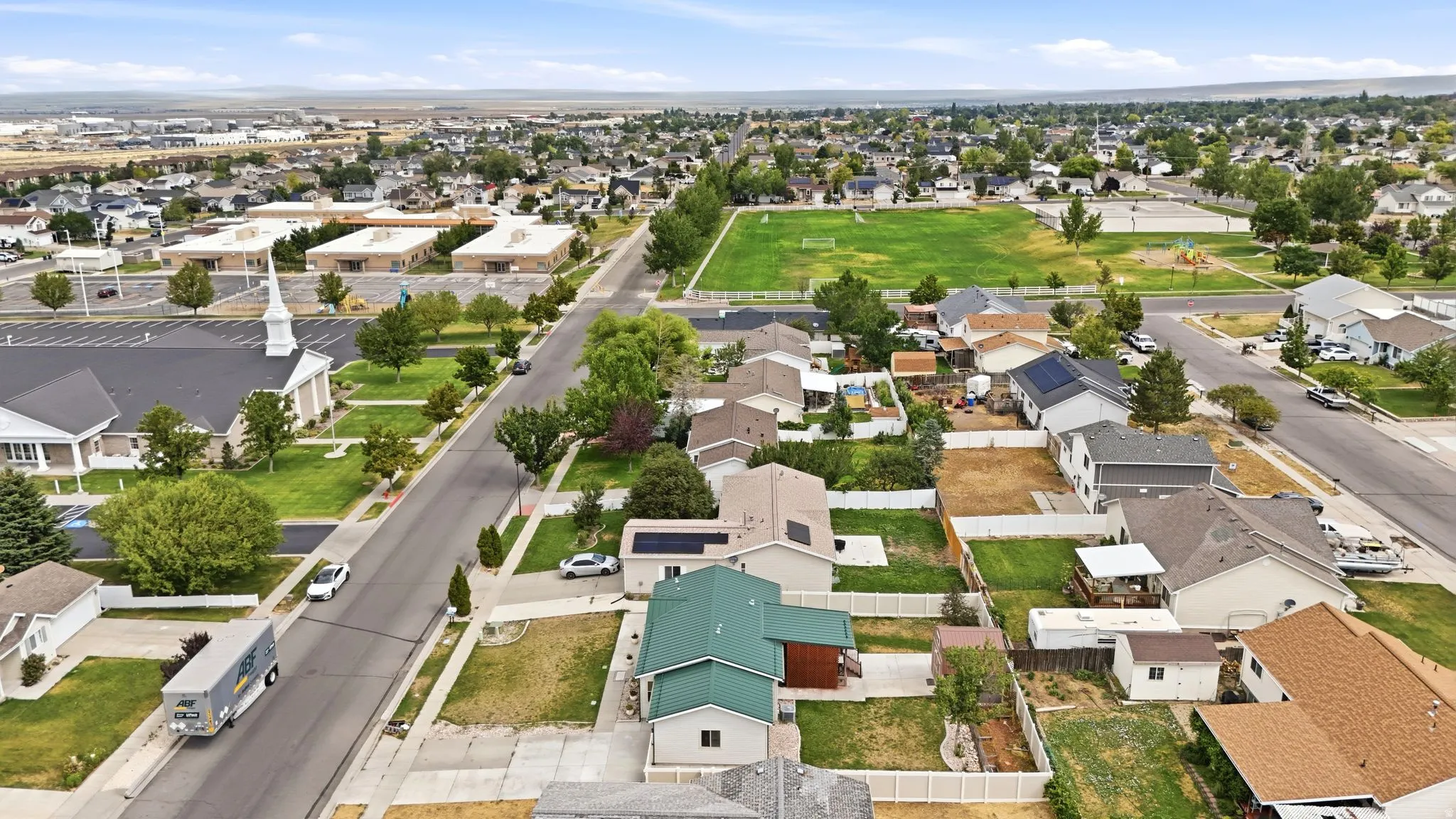 Residential neighborhood featuring a variety of single-family homes with pitched roofs and fenced backyards