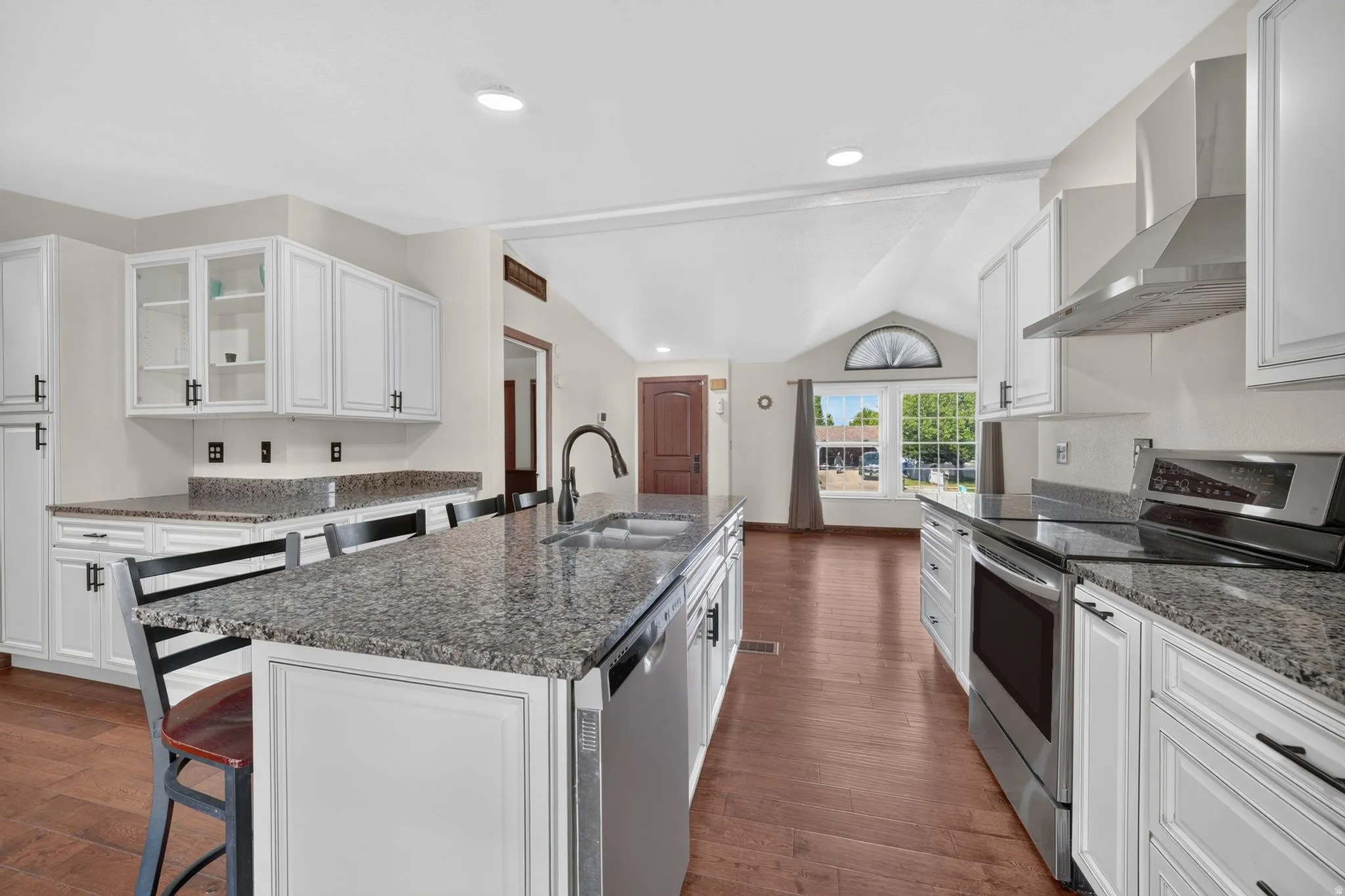 Kitchen featuring white shaker-style cabinetry, granite countertops, and stainless steel appliances