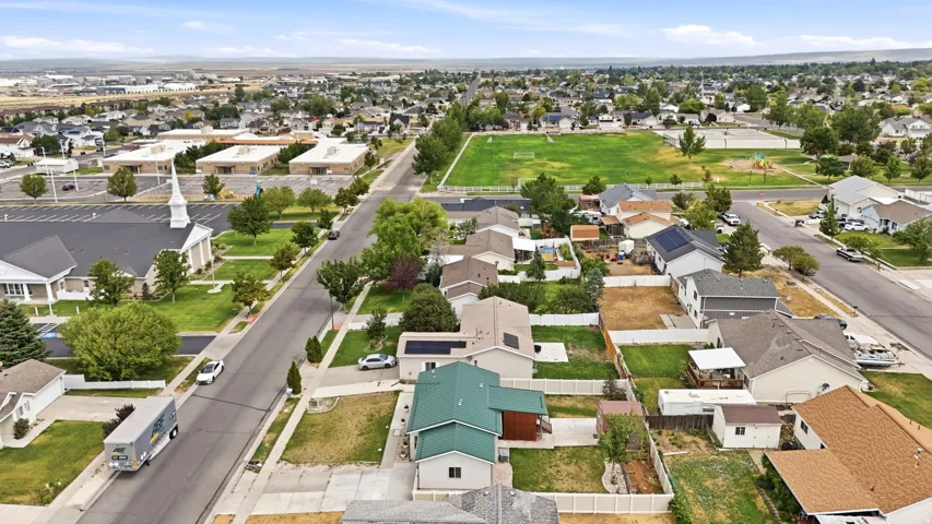 Residential neighborhood featuring a variety of single-family homes with pitched roofs and fenced backyards