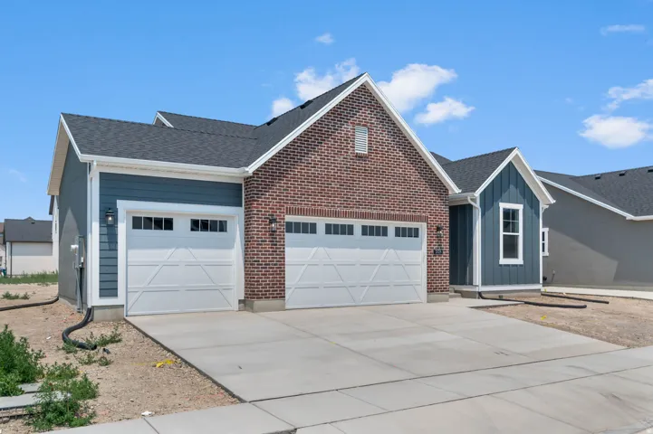 Contemporary exterior featuring brick and blue siding accents