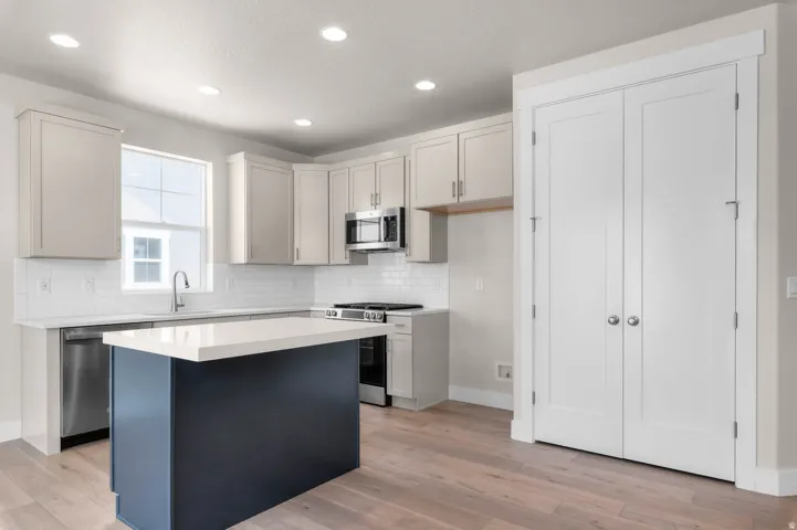 Bright kitchen featuring a central island with a contrasting dark base and light countertop