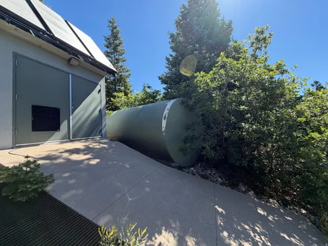 Building exterior featuring a concrete ramp, dual entry doors, and an integrated ventilation system
