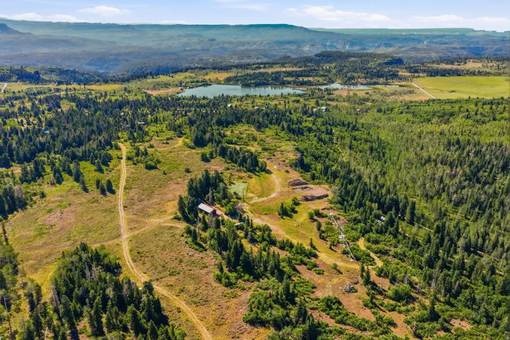 Expansive acreage featuring diverse topography, including wooded areas and open fields