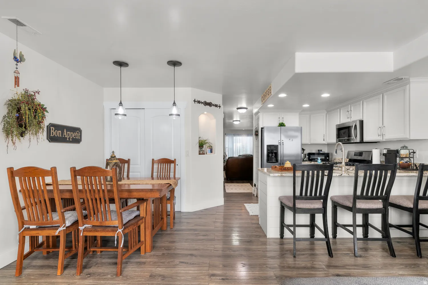 Open-concept kitchen and dining area featuring wood-finish flooring