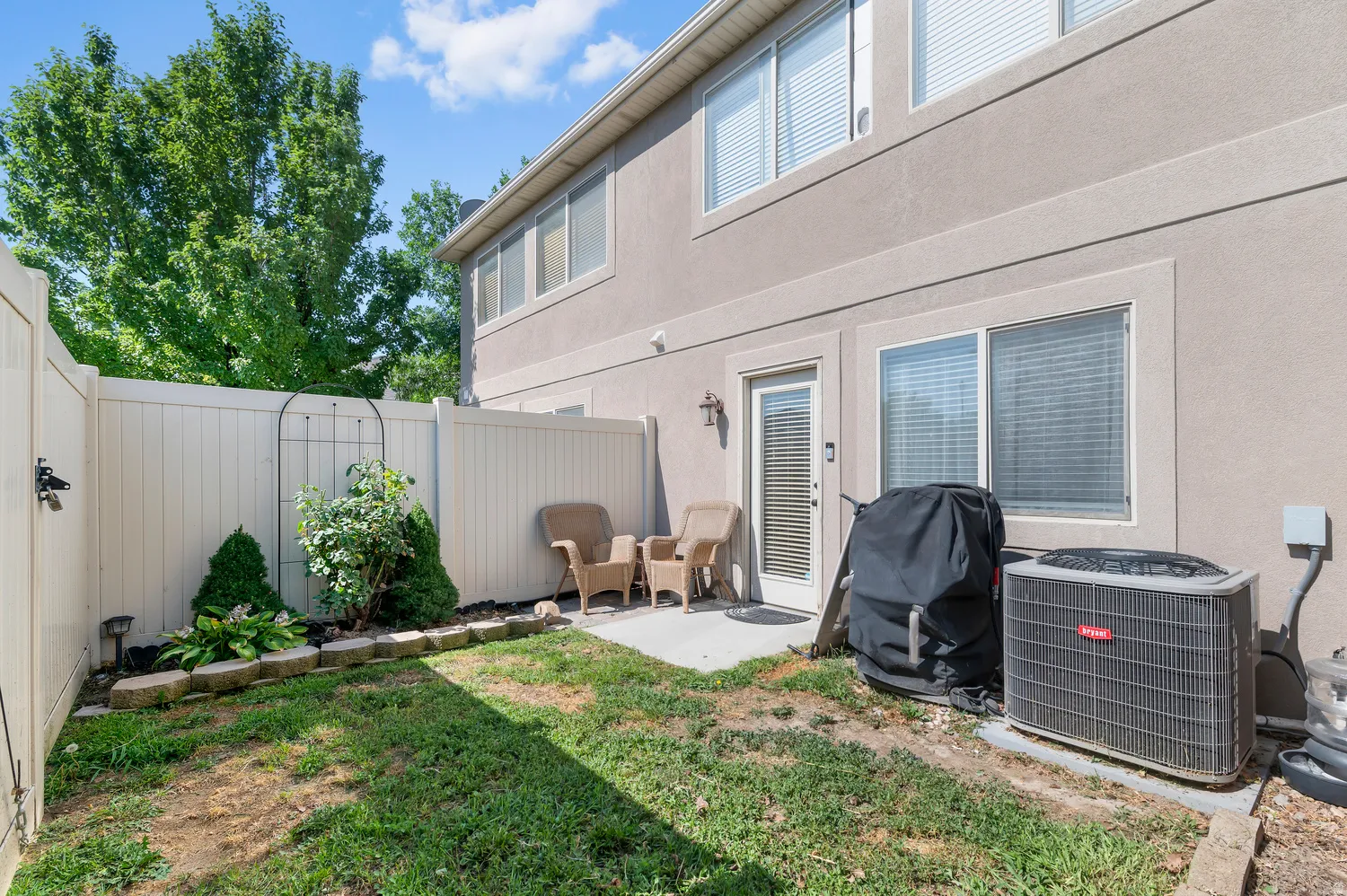Private outdoor patio area featuring a concrete slab, direct exterior access, and a perimeter privacy fence