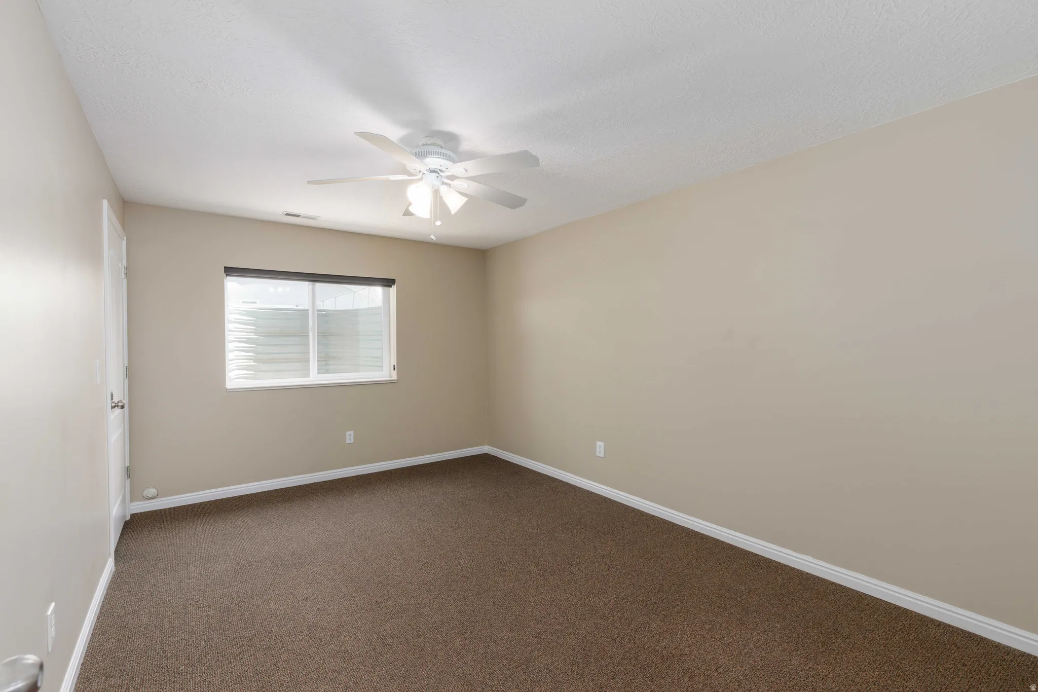 Room featuring neutral wall tones and brown carpet flooring