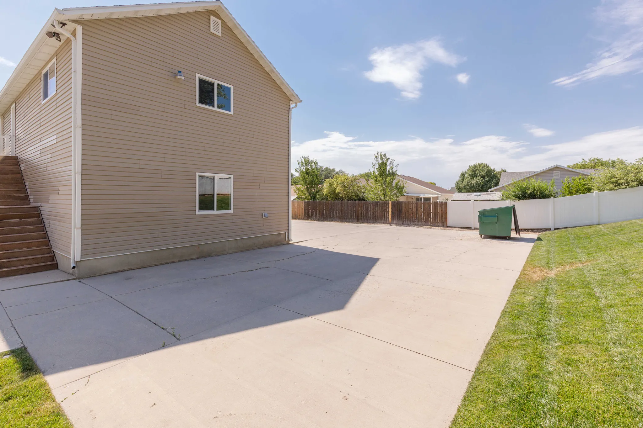 Two-story exterior with horizontal siding, multiple windows, and exterior lighting fixtures