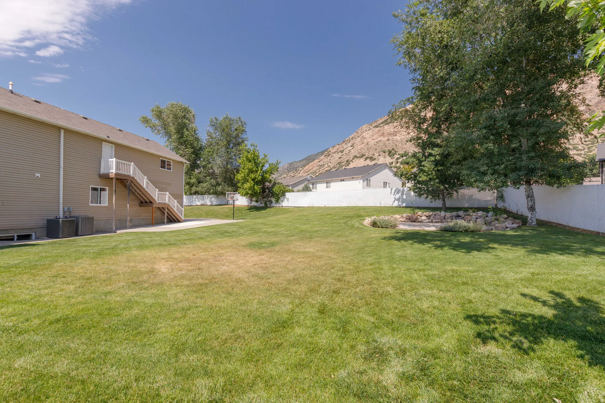 Expansive green lawn with mountain backdrop