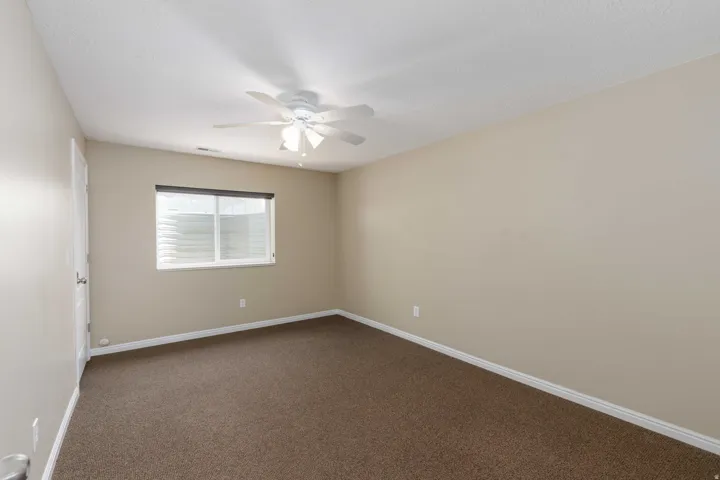 Room featuring neutral wall tones and brown carpet flooring