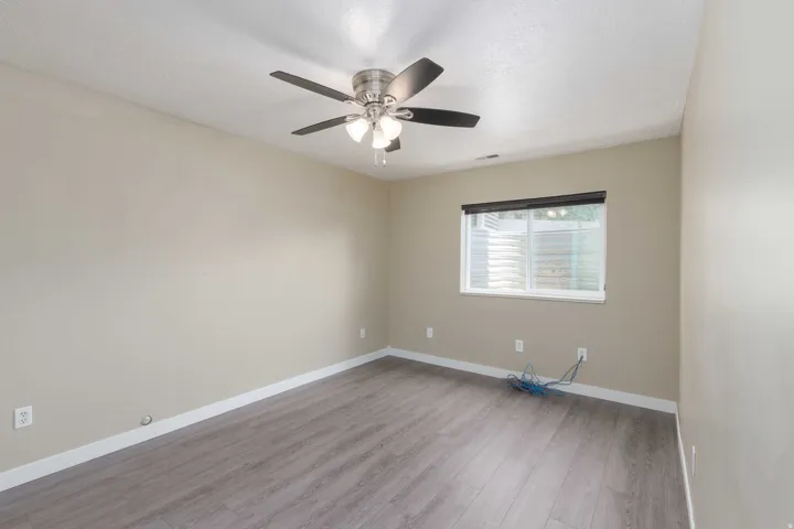 Neutral-toned walls complement the wood-finish flooring