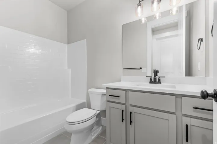 Bathroom featuring a light gray vanity with a white countertop and rectangular undermount sink