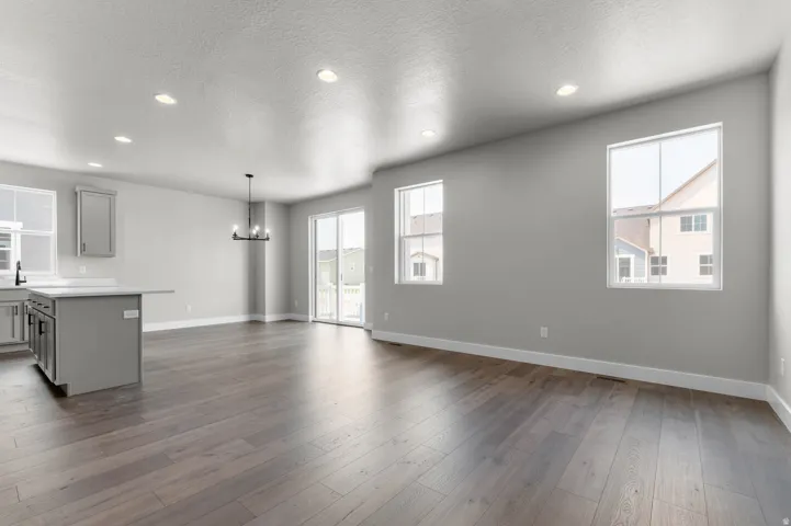 Spacious interior featuring wood-finish flooring, recessed lighting, and a contemporary chandelier