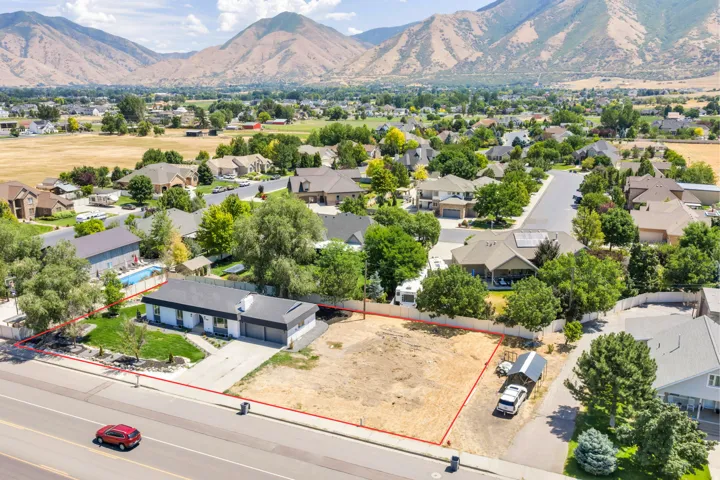 Expansive lot featuring a single-story residence with an attached two-car garage, a detached carport, and a private swimming pool