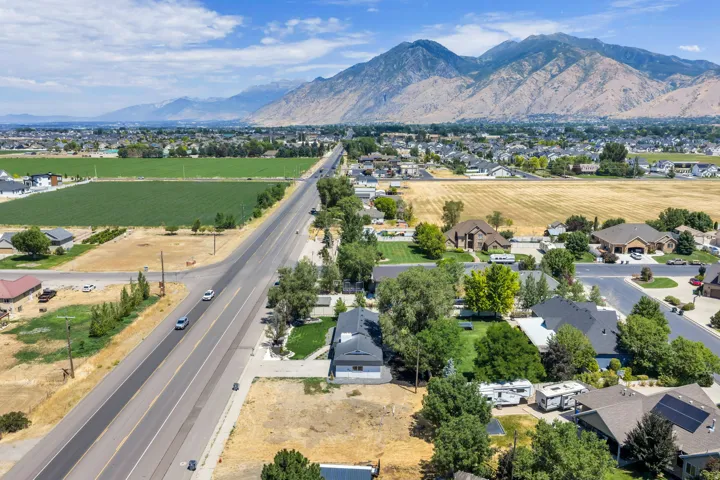 Expansive aerial perspective showcasing a residential area with a prominent mountain range backdrop